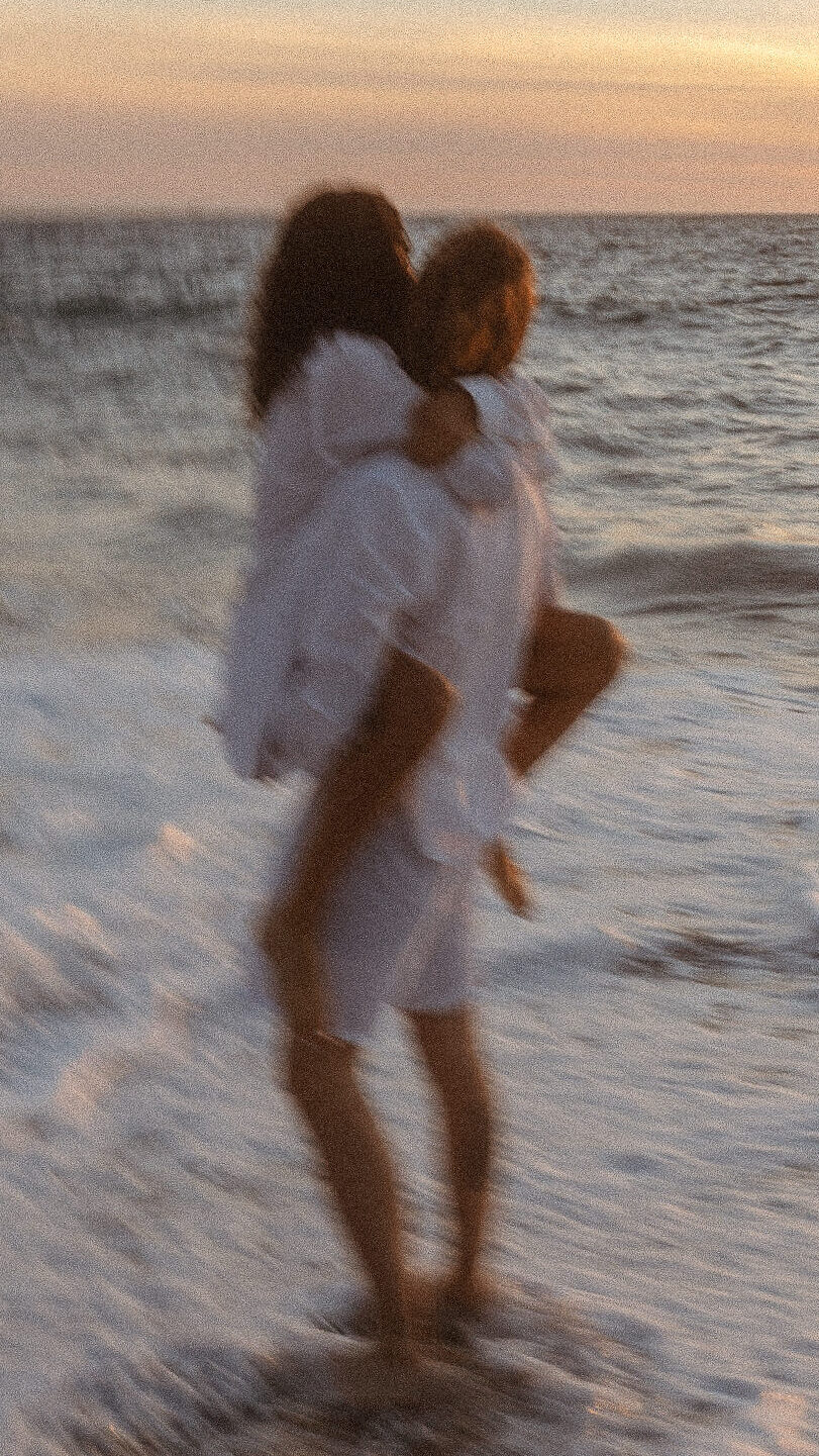 Creative Couple holding each other while dancing on a Malibu Beach
