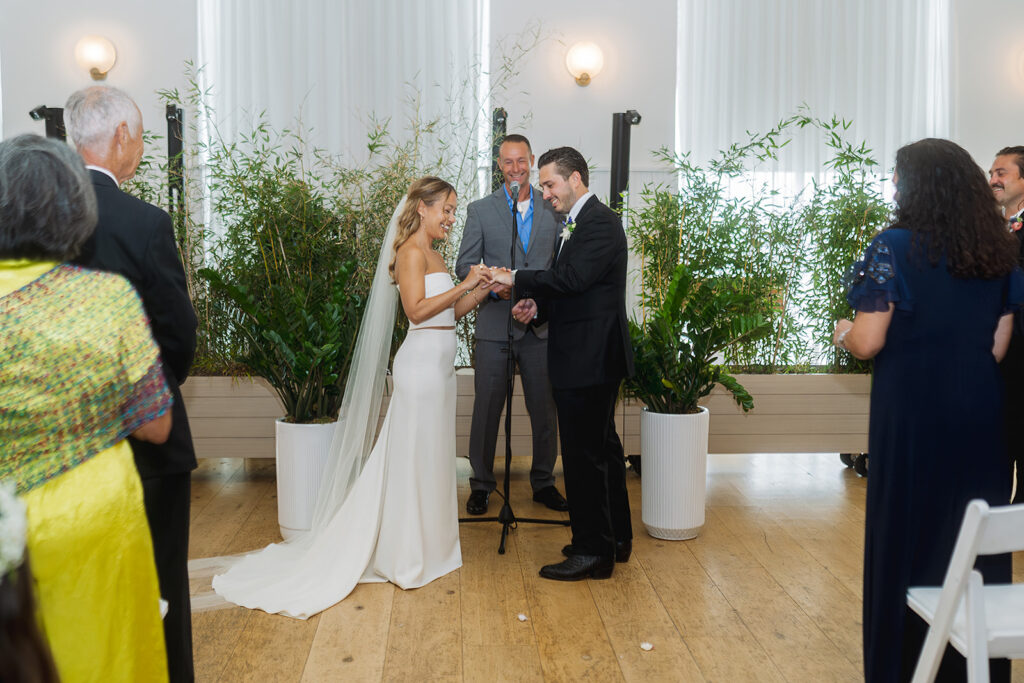 Couple exchanging rings during their ceremony at The Rockaway Hotel.