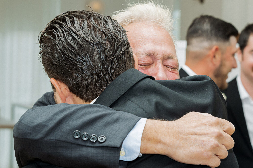 Dad hugging the groom crying after their ceremony at The Rockaway Hotel.