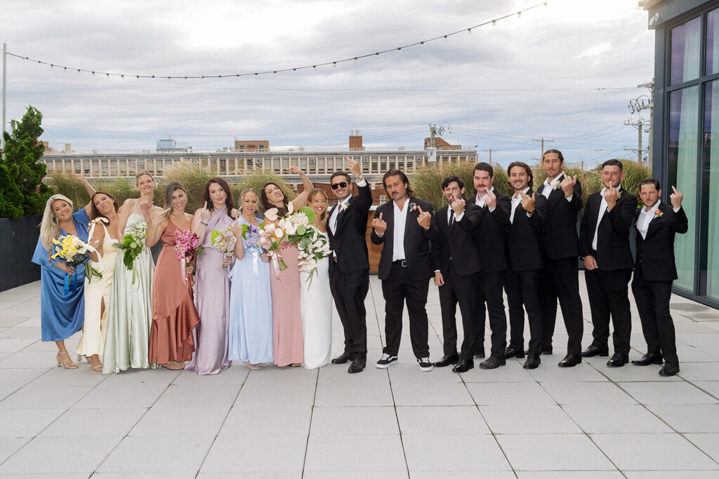 Wedding party posing together at The Rockaway Hotel.