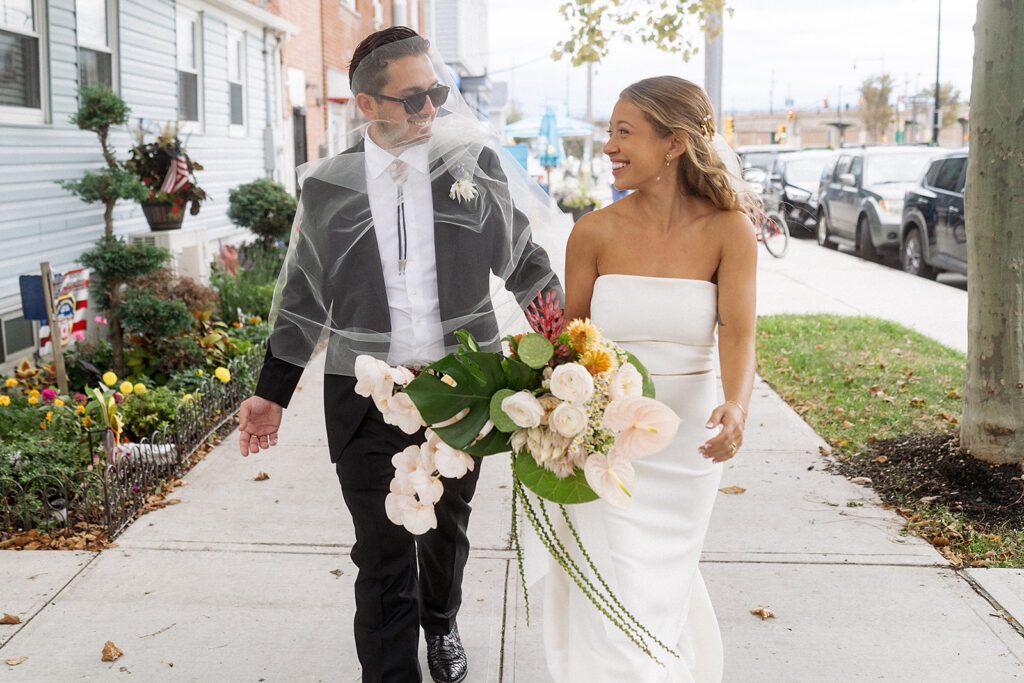 Bride and Groom photos on the streets of Rockaway Beach in New York.