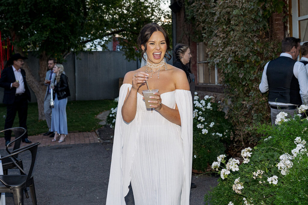 Bride with her first drink of the night