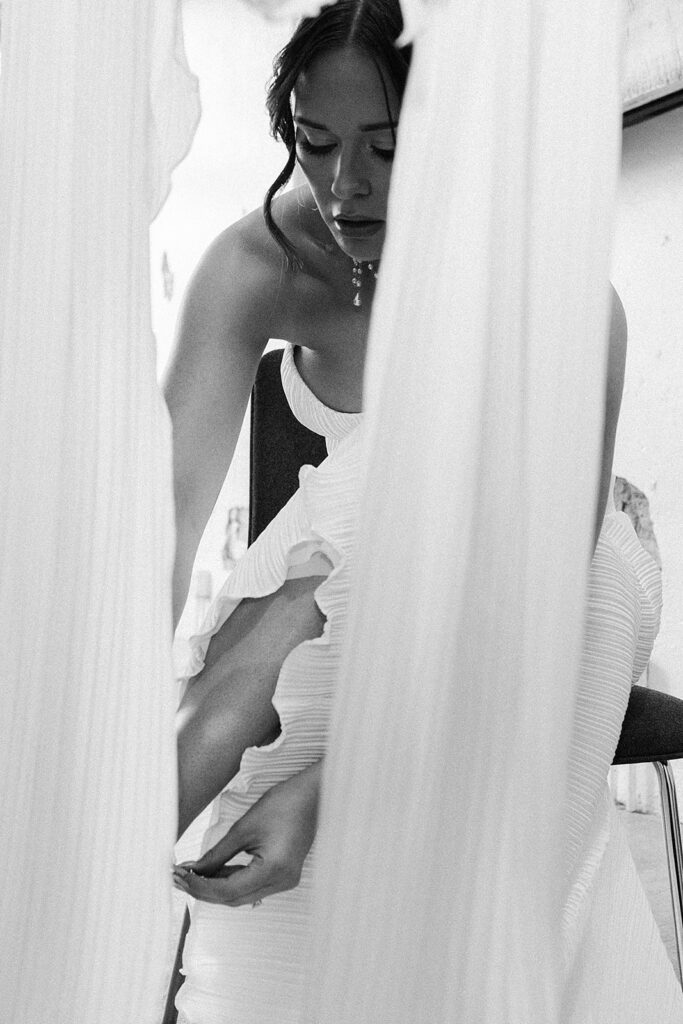 Bride getting ready in natural light, wearing her mother’s vintage wedding dress