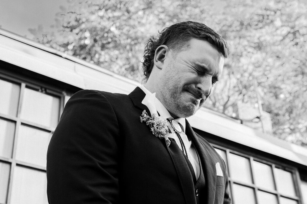 Groom crying as he sees the bride