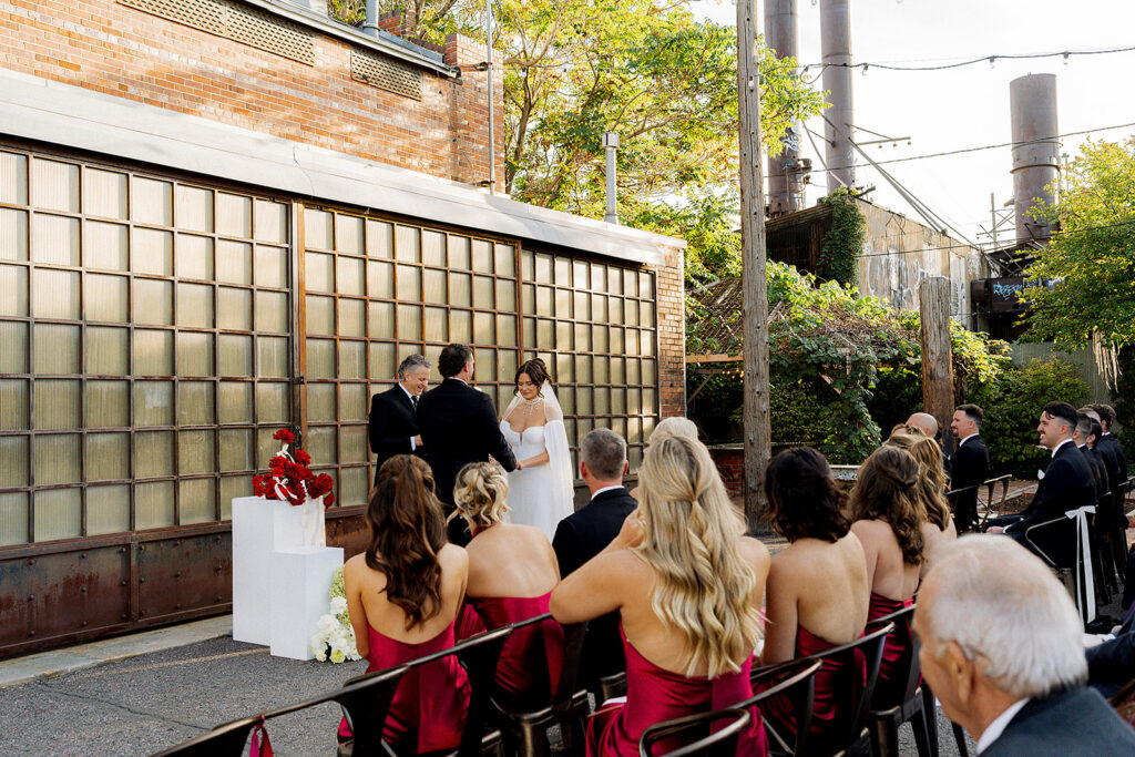Minimalist ceremony setup with greenery and industrial touches