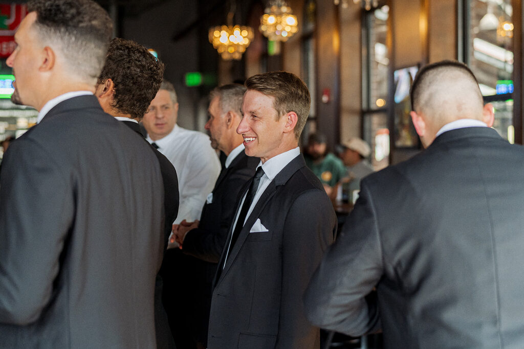 Groom and groomsmen hanging out before the wedding ceremony